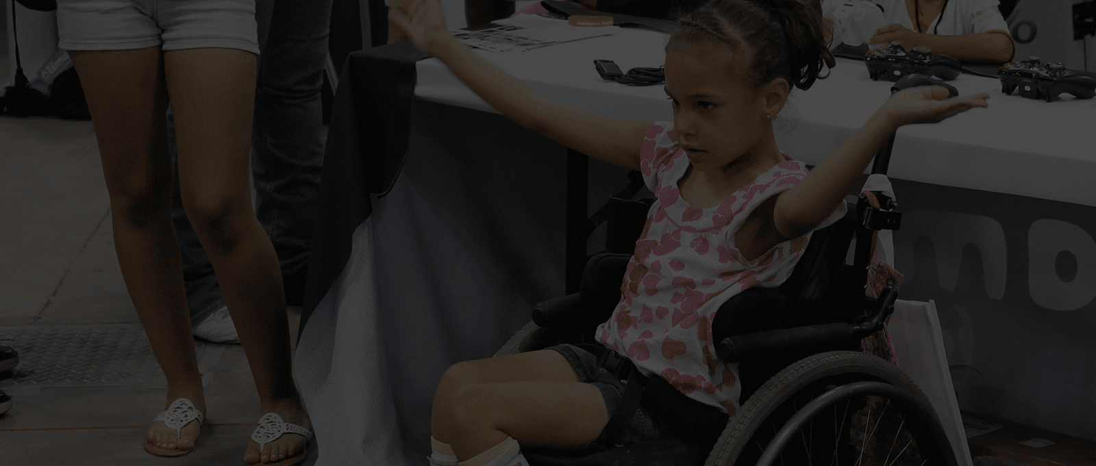 Photo of a little girl in a wheelchair playing Fruit Ninja